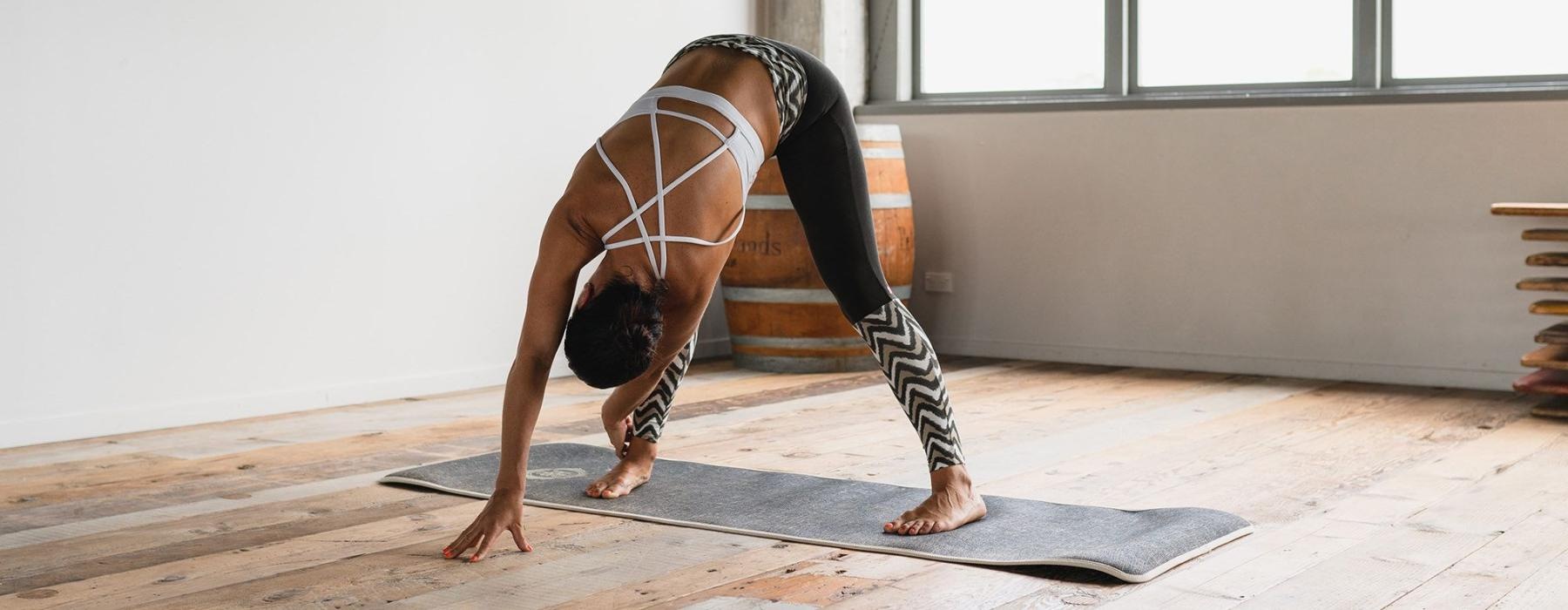 woman doing yoga in sun-filled studio